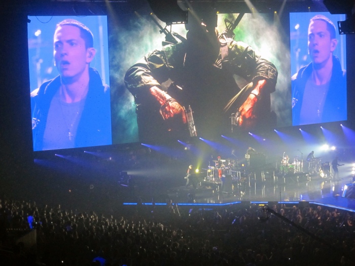 Giant screens project Eminem's image above the distant stage